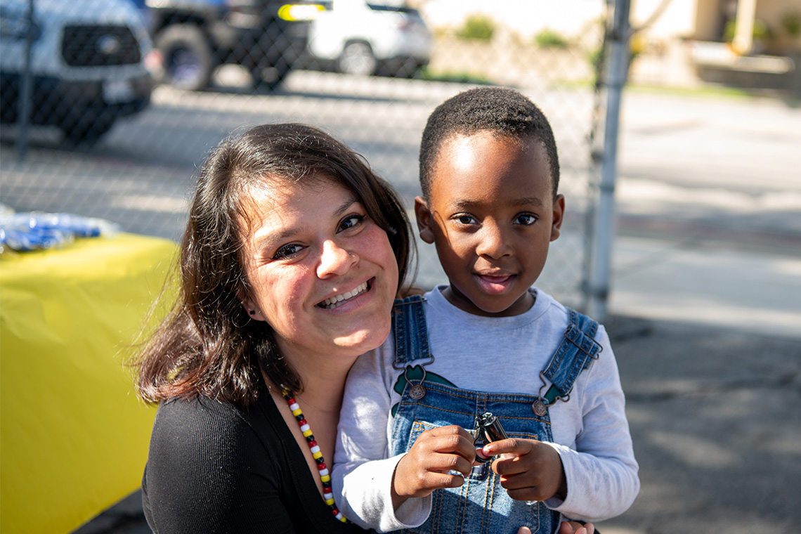 A child smiling with his child care provider.