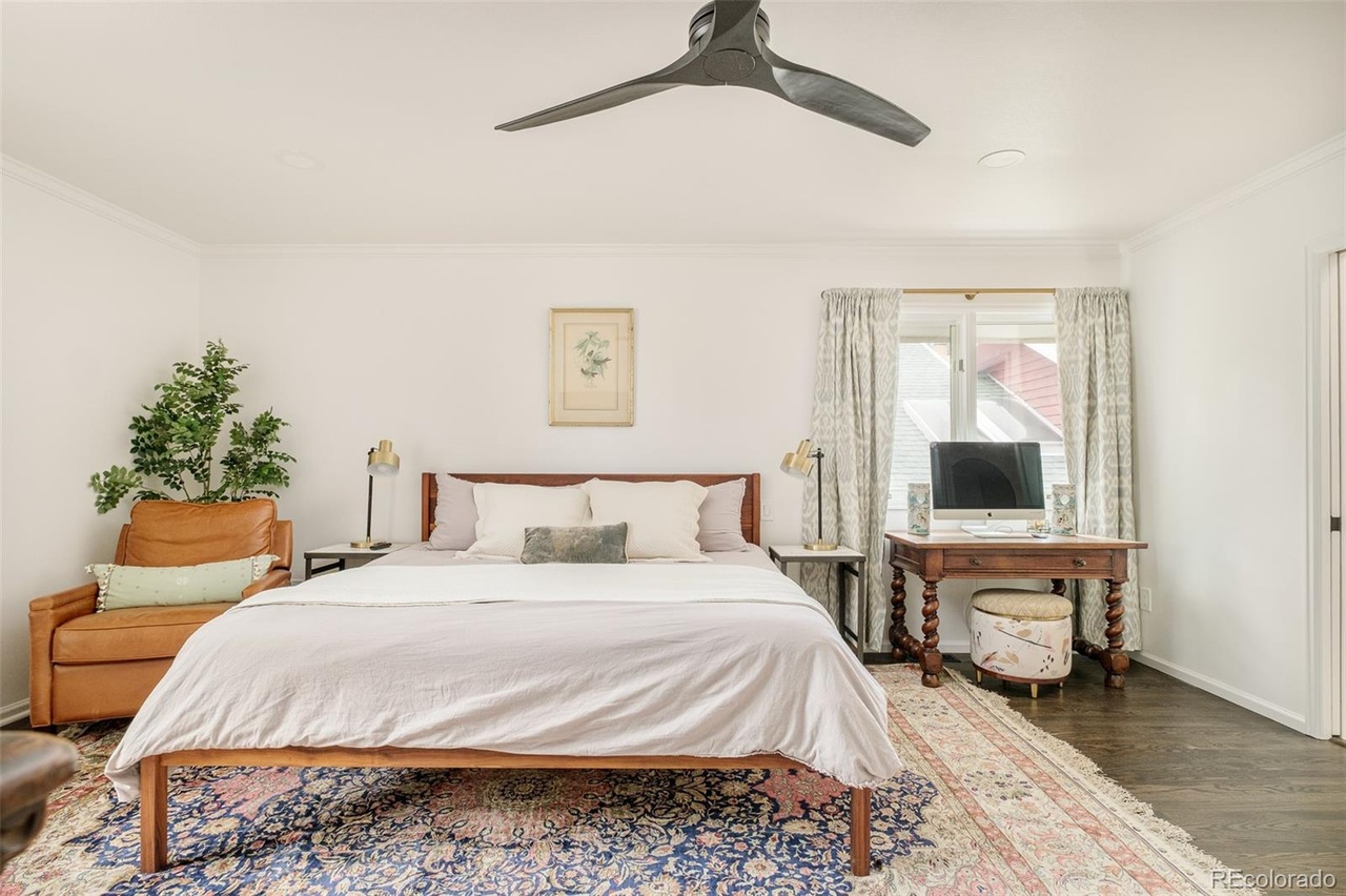 Primary bedroom remodel with hardwood floors, large windows, and refined interior design that highlights DDB’s craftsmanship.
