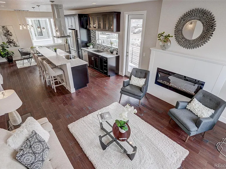 Formal living room layout with two sofas, statement art, and detailed molding