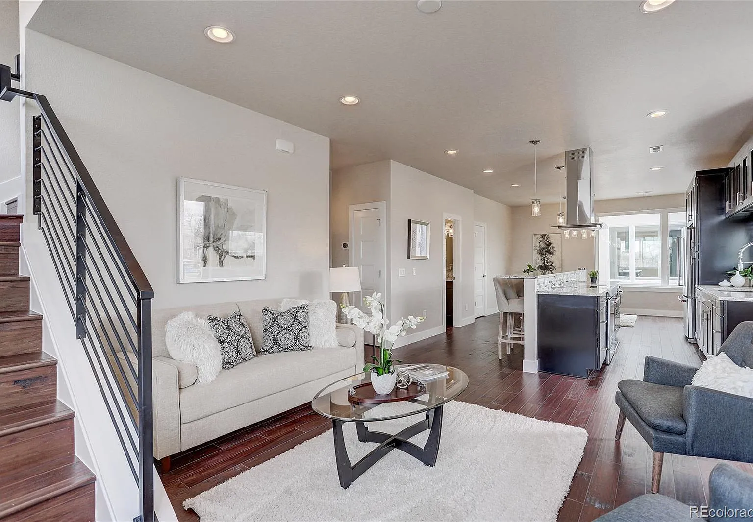 Entryway with staircase, natural wood railing, and elegant wall accents