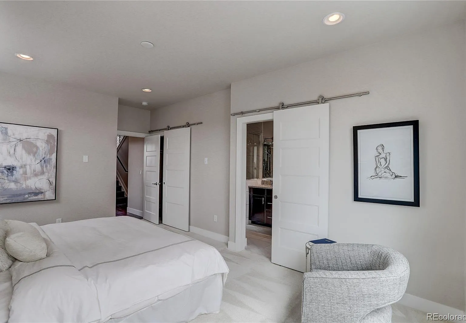 Hallway view with access to bedrooms and soft, neutral wall tones