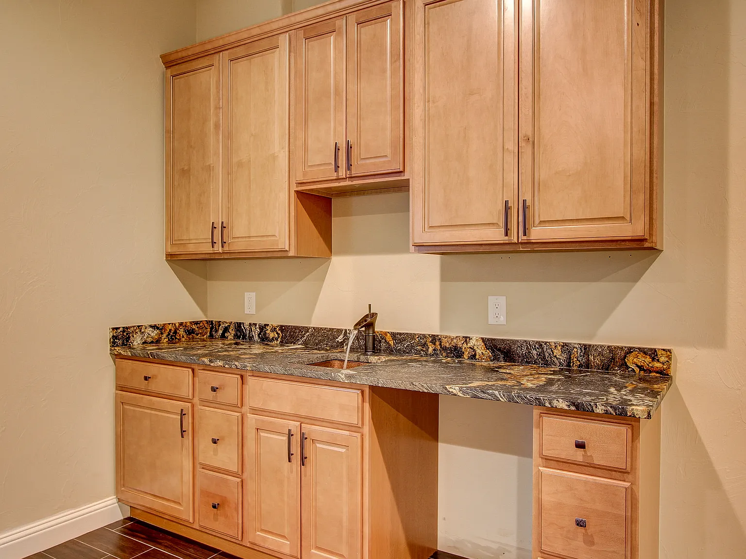 Laundry or utility room with built-in upper and lower cabinetry and granite work surface