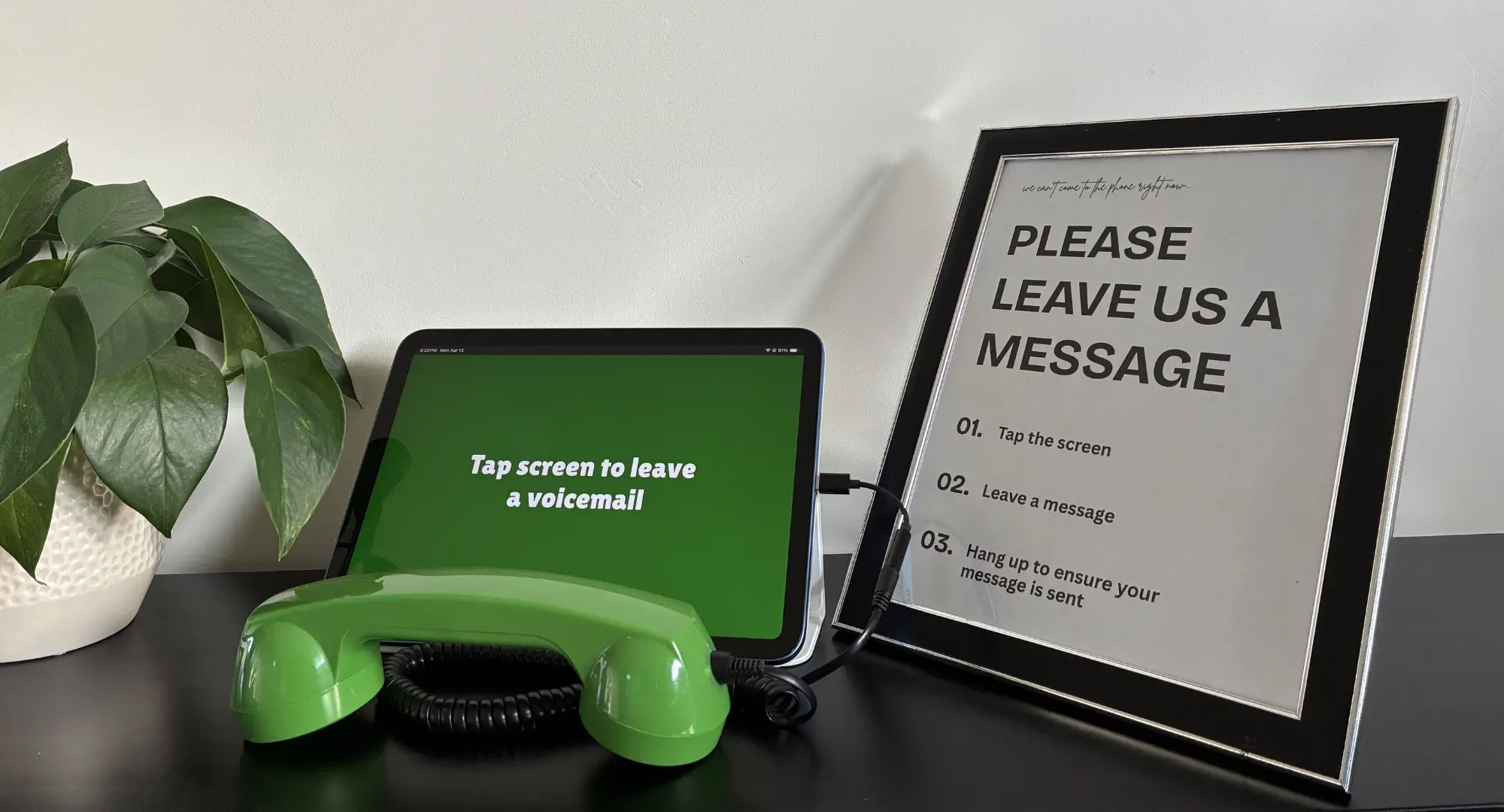 Wedding audio guest book phone booth setup where guests tap a tablet and use a handset to leave a voicemail