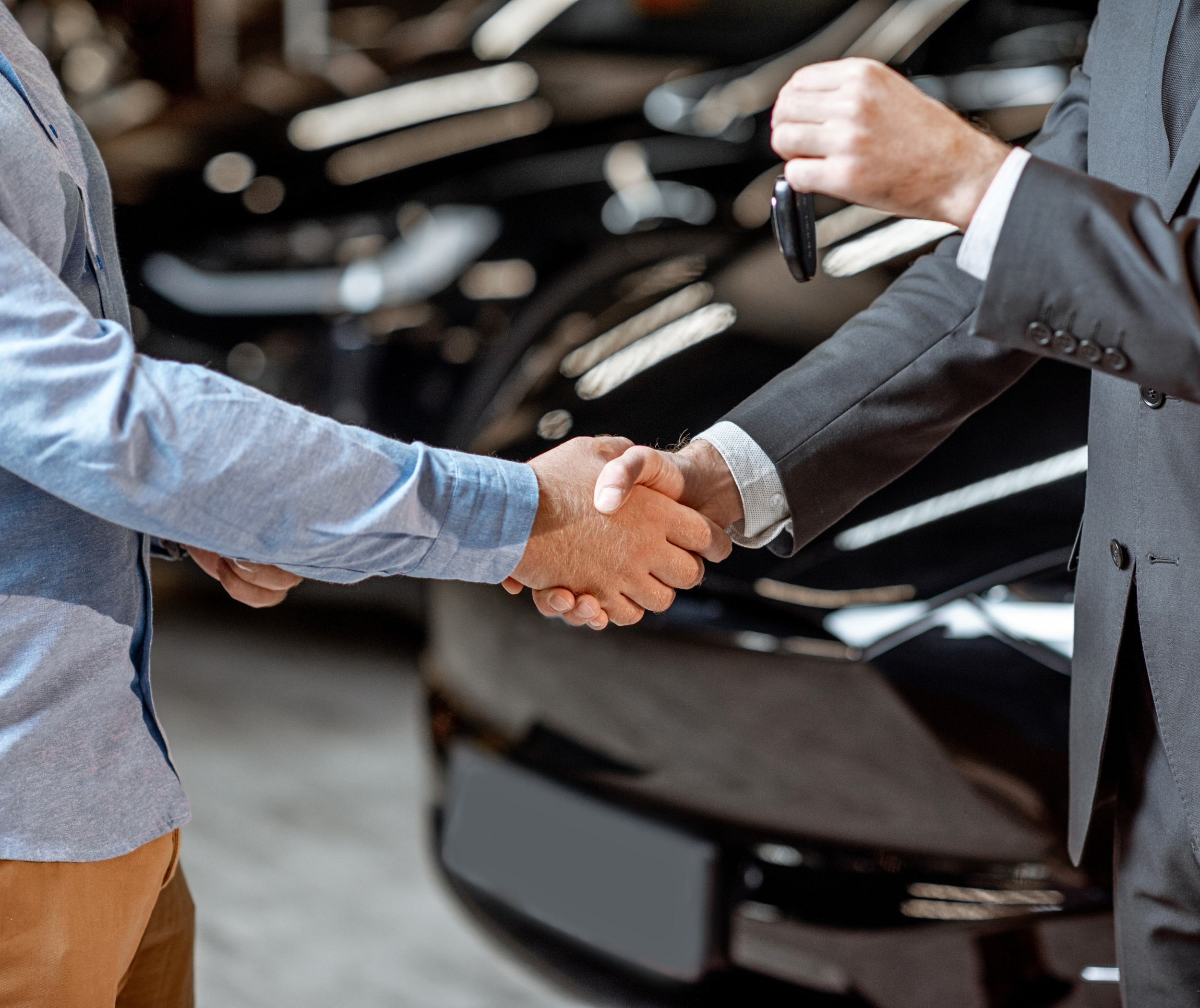 Keys handed car buying service laptop