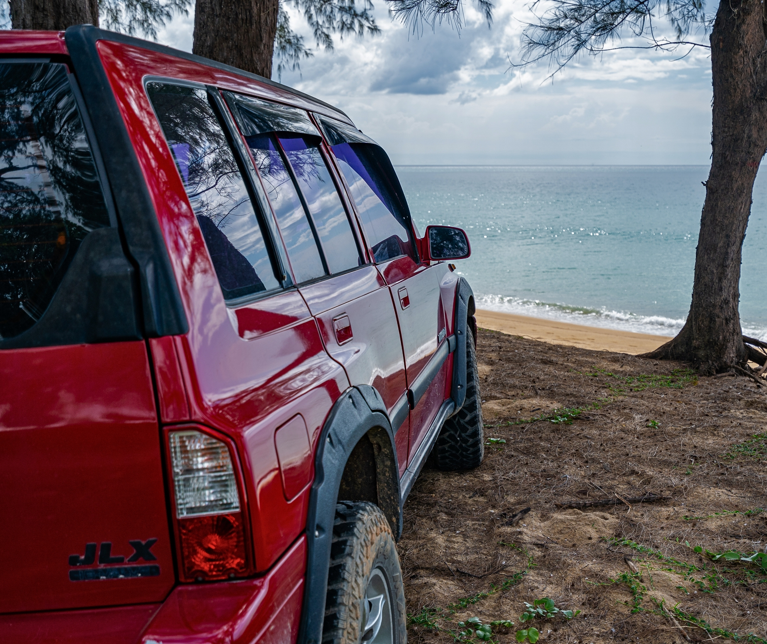 Car by beach image for car buying service slider laptop