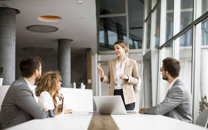 A professional team collaborating around a conference table during a strategy session at a Full Service Marketing Agency.