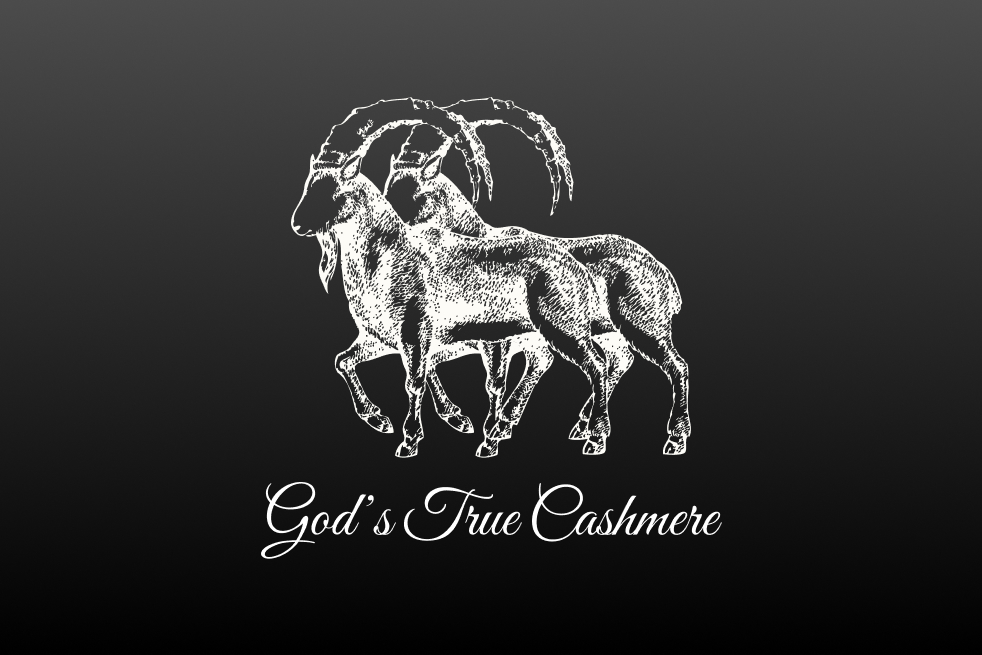White sketch of two alpine ibexes with large curved horns above the text 'God’s True Cashmere' on a black gradient background.