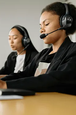 Image of employees wearing headphones 