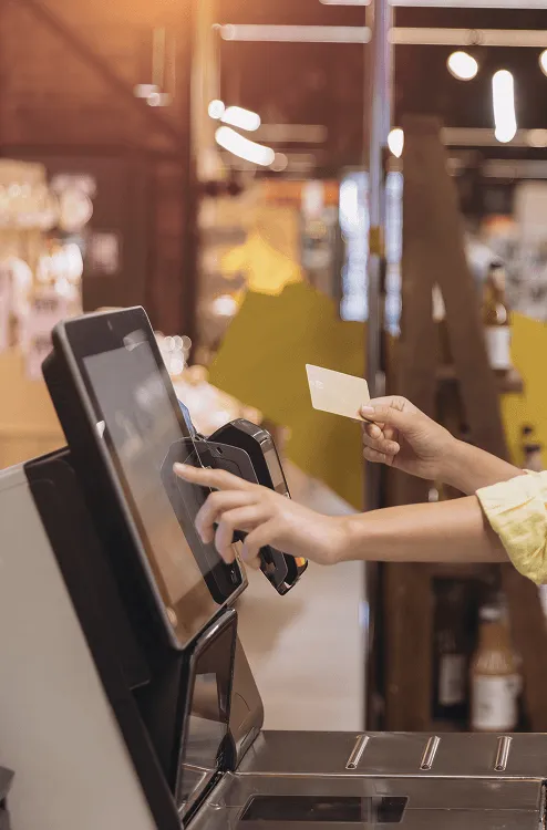 Image of a women clicking a point of sale machine 