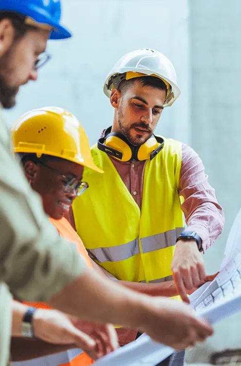 Group of engineer looking at a building schematic 