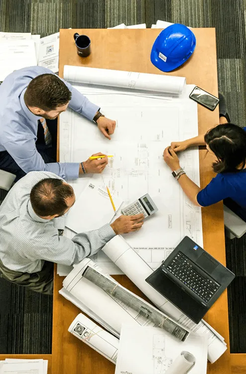 Group of engineers working on a building schematic
