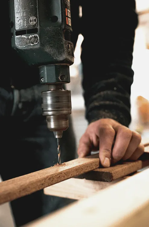 Image of a person drilling into a wood