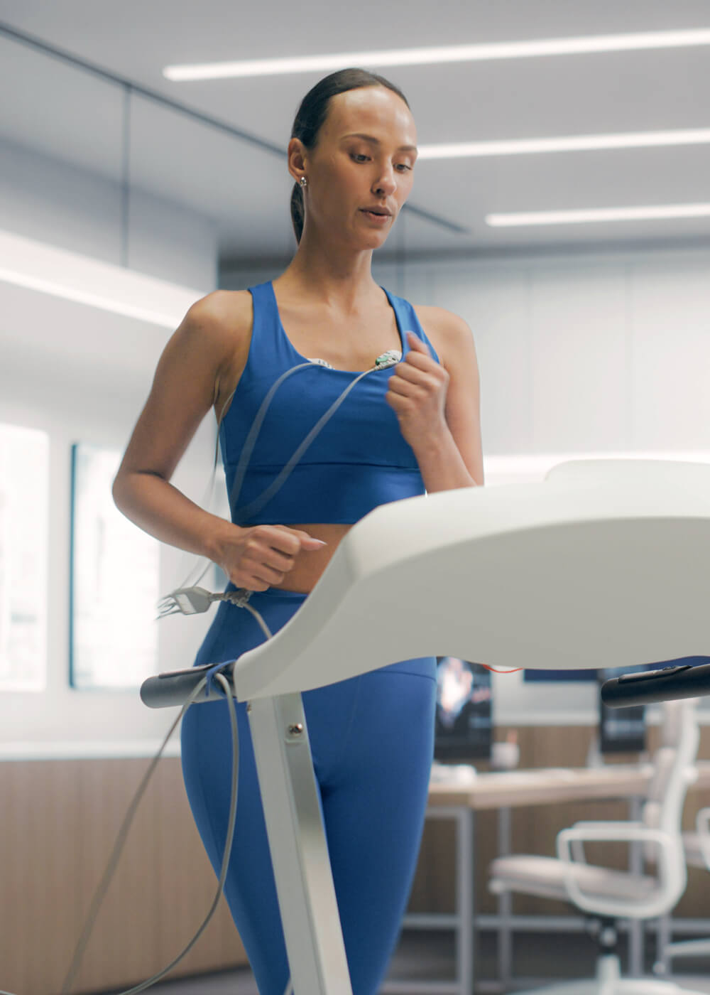 Women running on a threadmill monitoring her vital signs