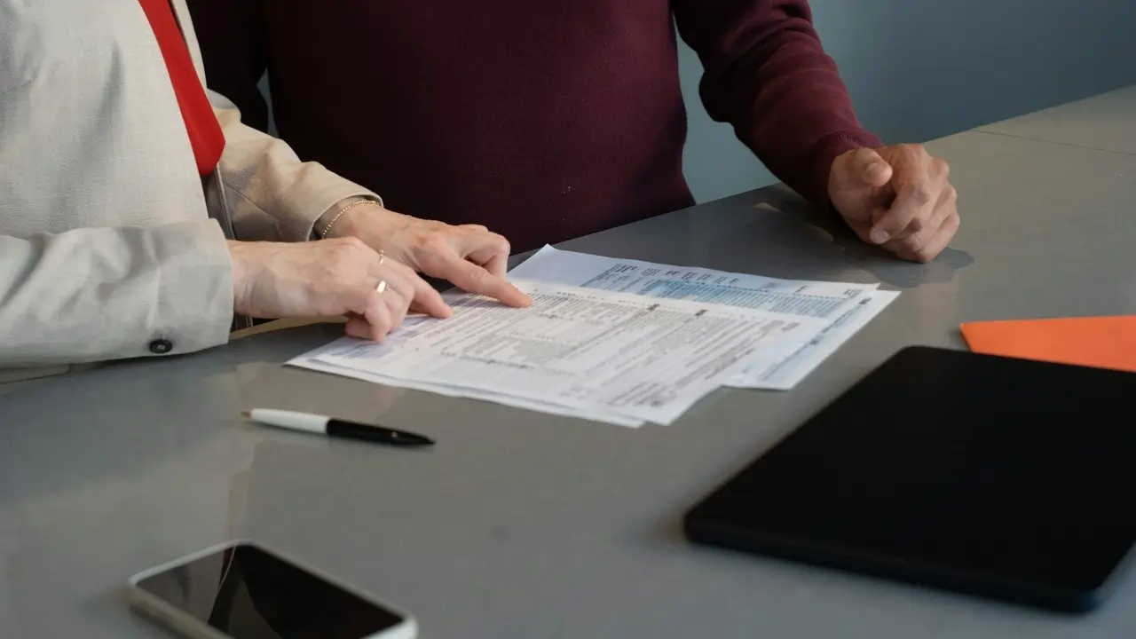 Two people reviewing documents at a table