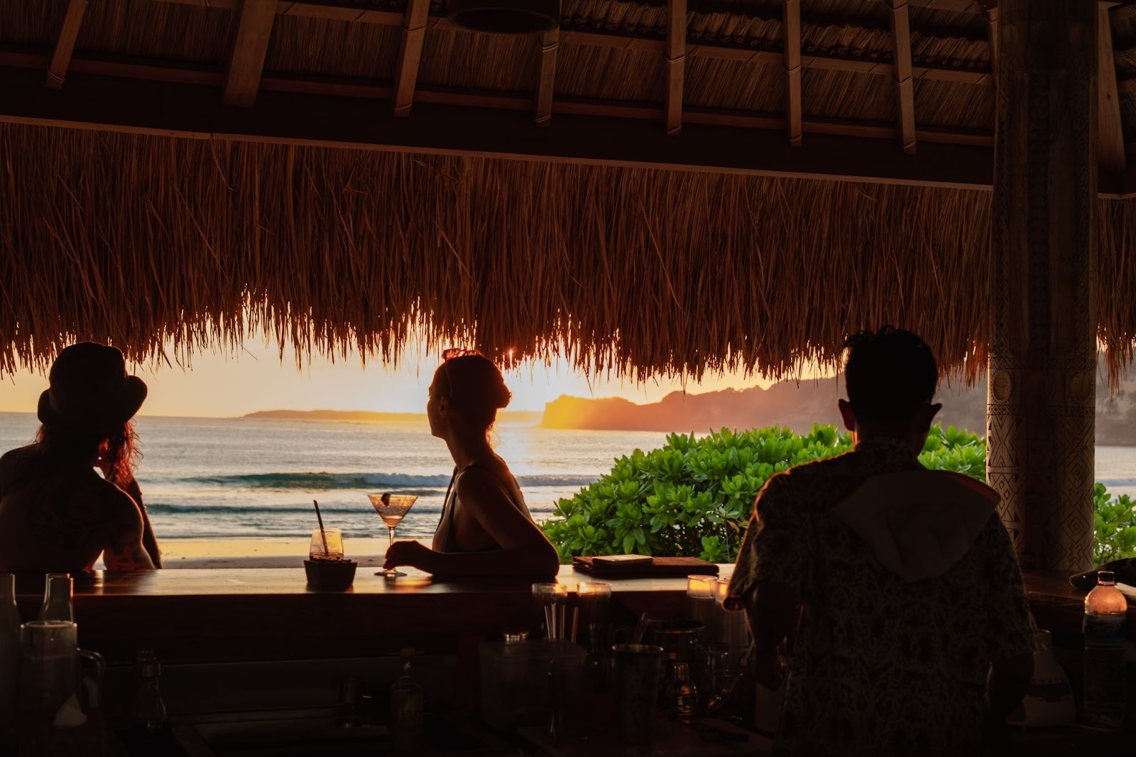People enjoying sunset cocktails at a beach bar in Sumba