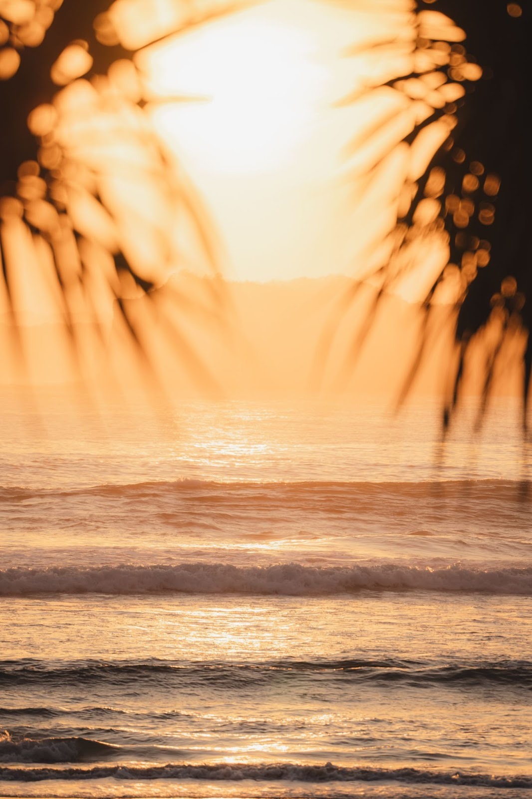 Tropical sunset over the ocean at The Sanubari, capturing the peaceful barefoot luxury atmosphere.