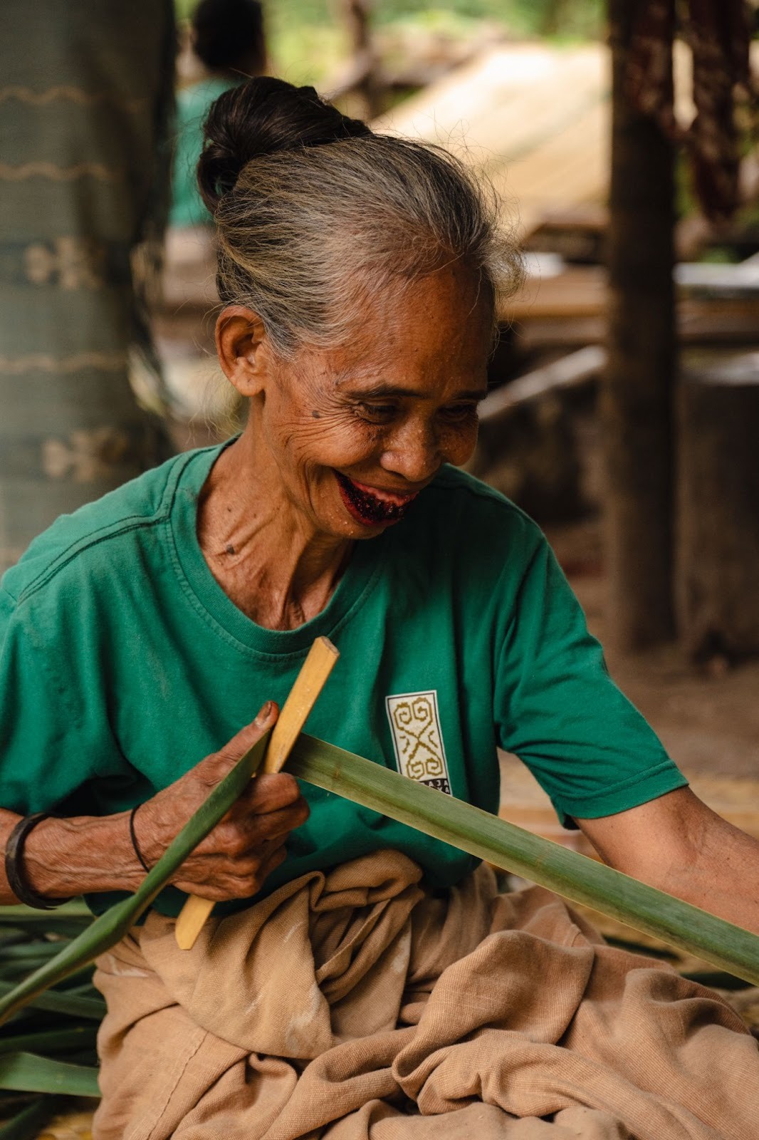 Sumbanese elder crafting traditional materials by hand, preserving ancestral skills and cultural knowledge.