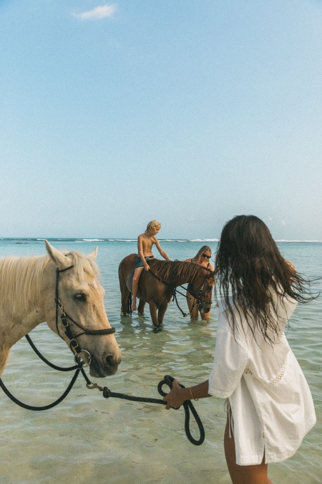 Horseback riding in shallow ocean waters in West Sumba, alcohol-free nature experience for intentional travelers