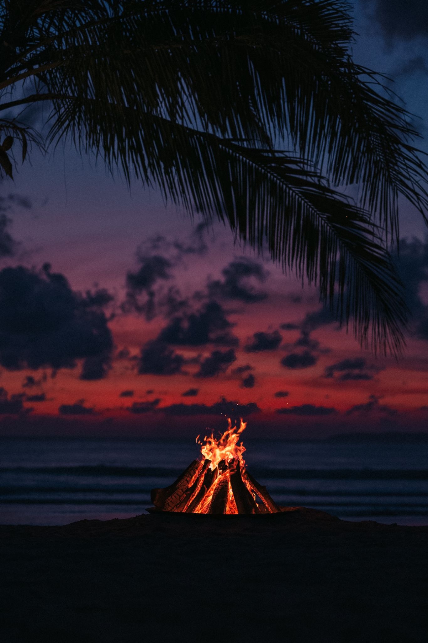 Beachfront bonfire experience at The Sanubari Sumba during sunset, offering relaxing evenings by the ocean at a luxury Sumba Island hotel.