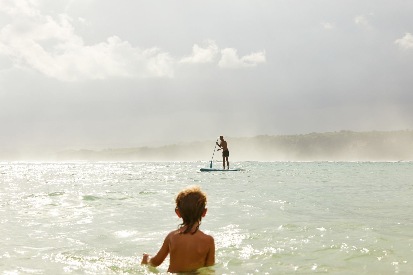 Stand-up paddleboarding at The Sanubari Sumba island hotel with clear turquoise waters