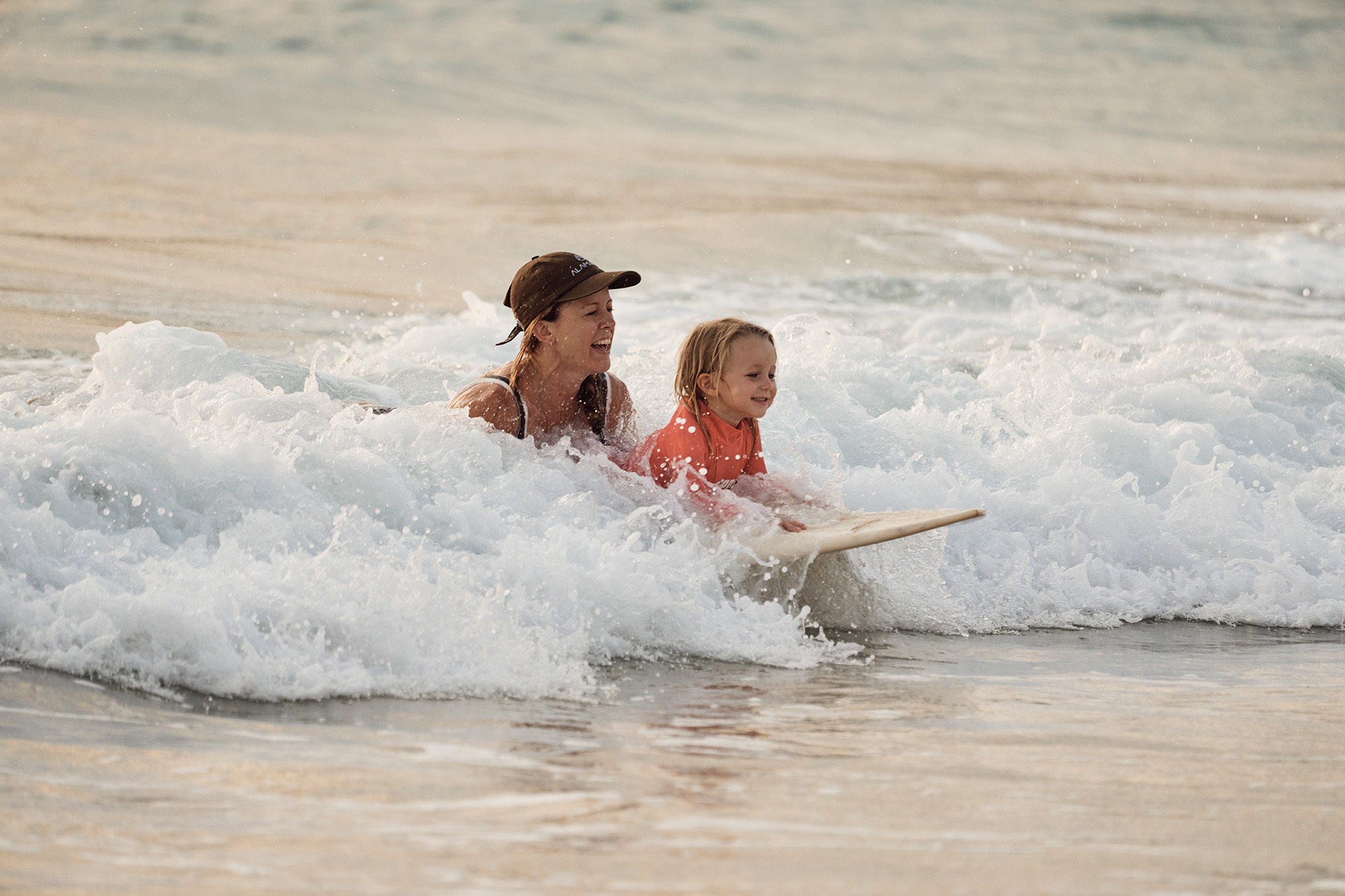 Guest picking a surfboard from the board rental shed at The Sanubari resort in Sumba
