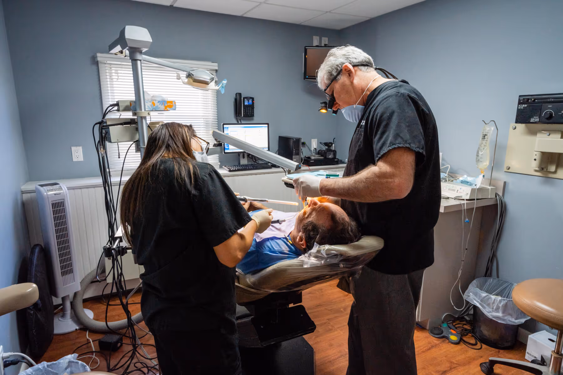 A man getting his teeth checked by a dentist.