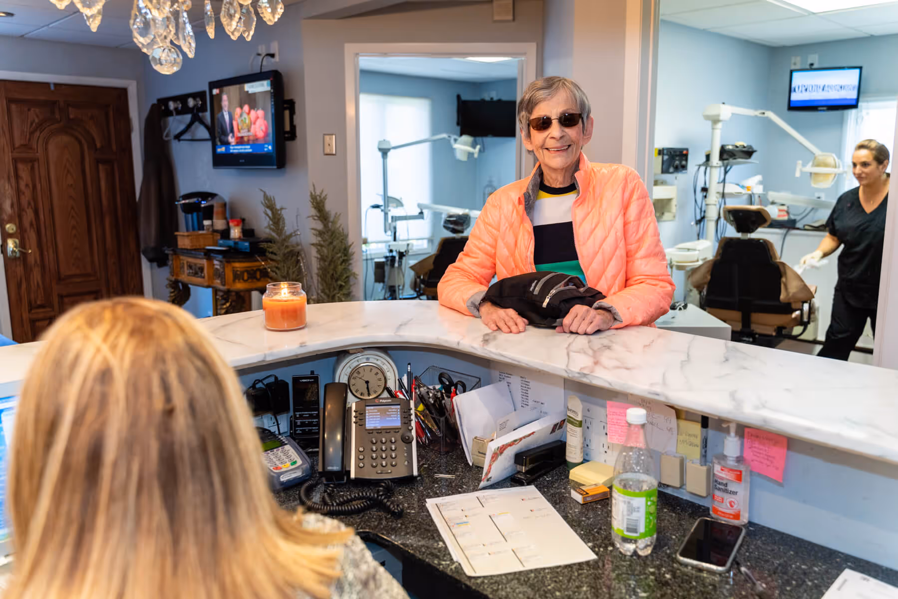 A woman sitting at a counter in a salon.