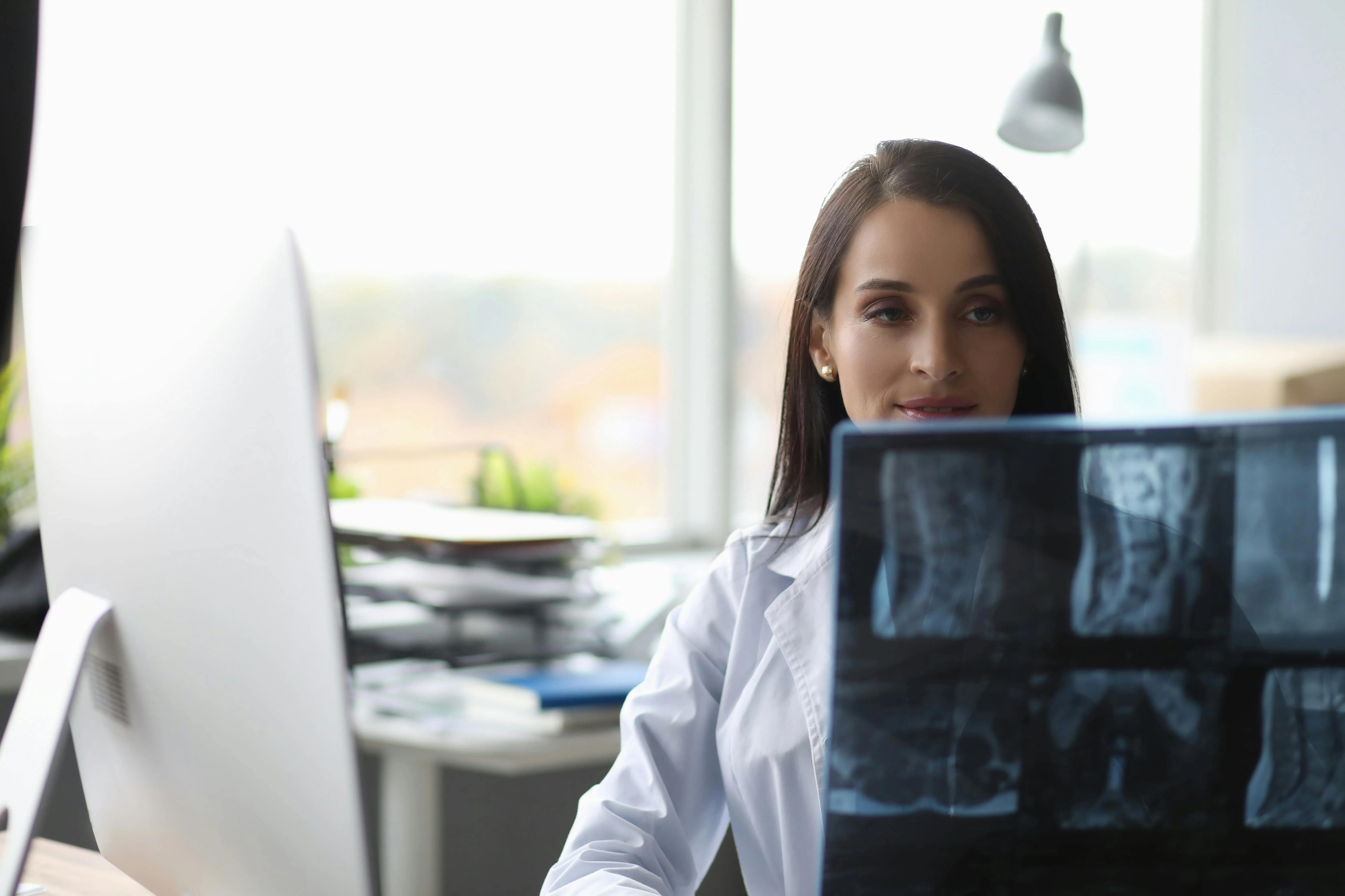 Medical practitioner in front of computer