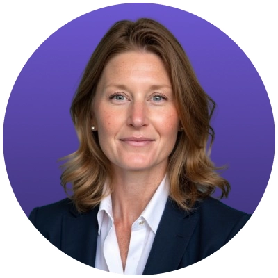 Professional headshot of a woman with shoulder-length light brown hair wearing a navy blazer and white shirt.
