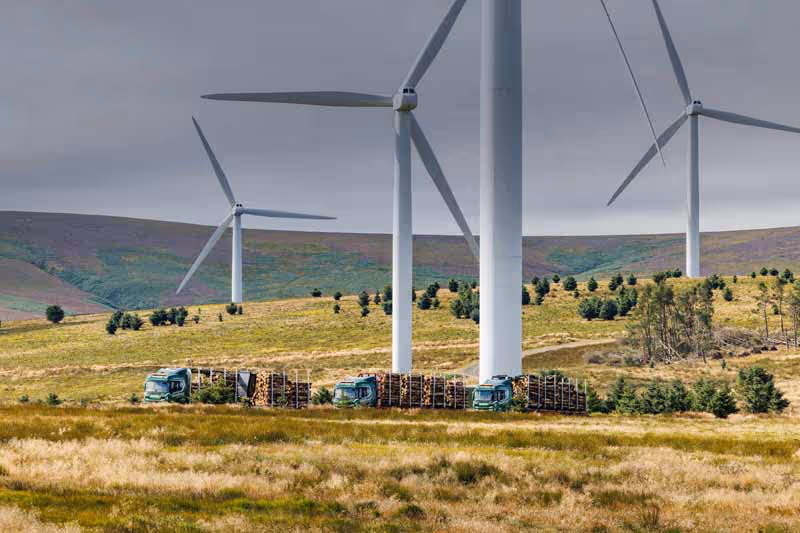 Windfarm with logging lorries in the foreground