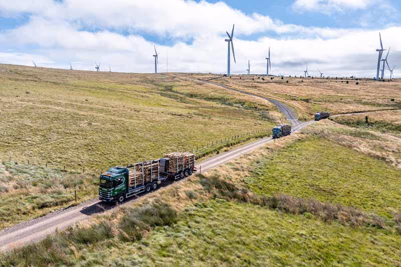 Euroforest Lorries with Wind Farm in background