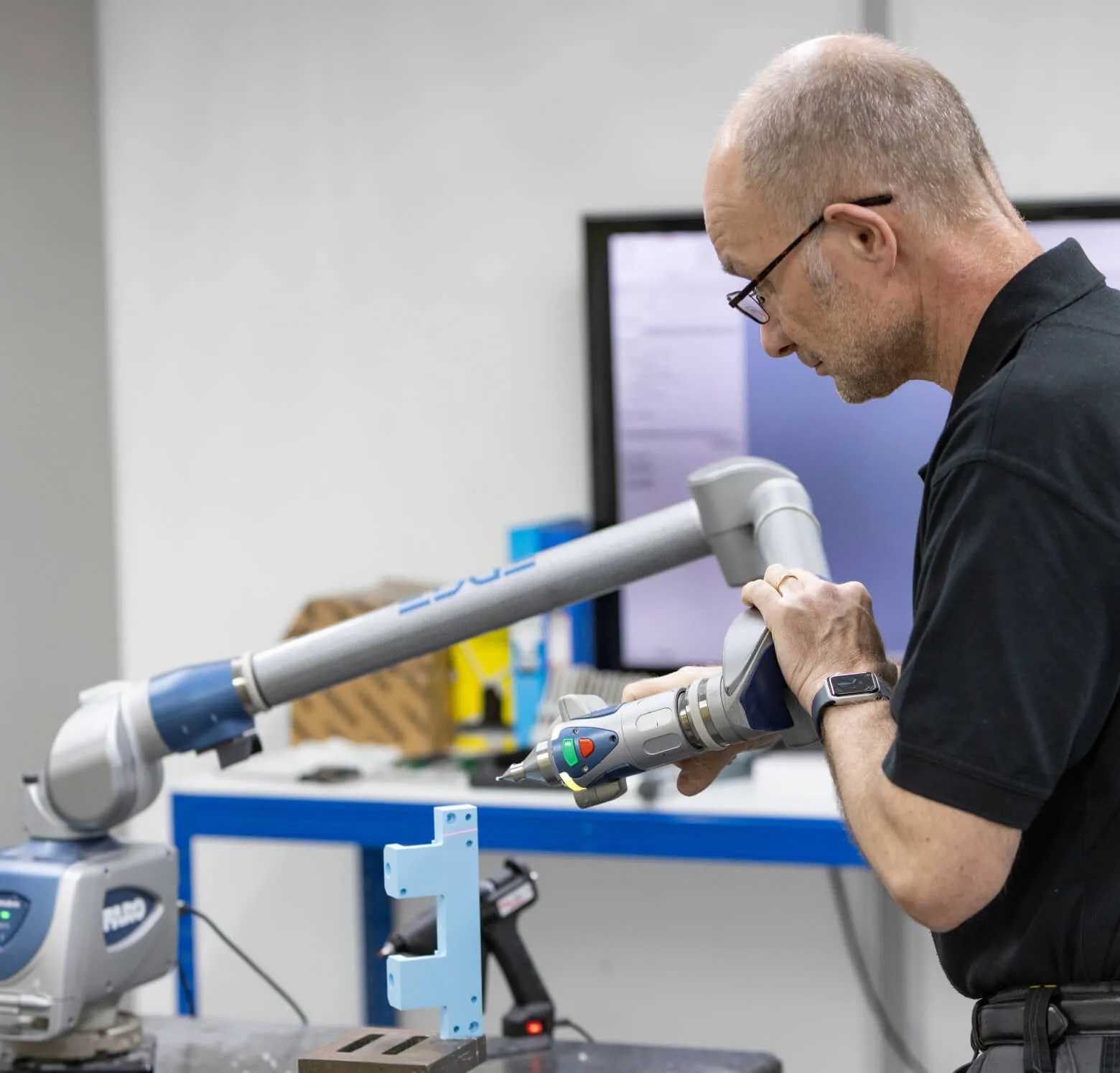 Engineer inspecting a fixture with a FARO portable measuring arm at Shape