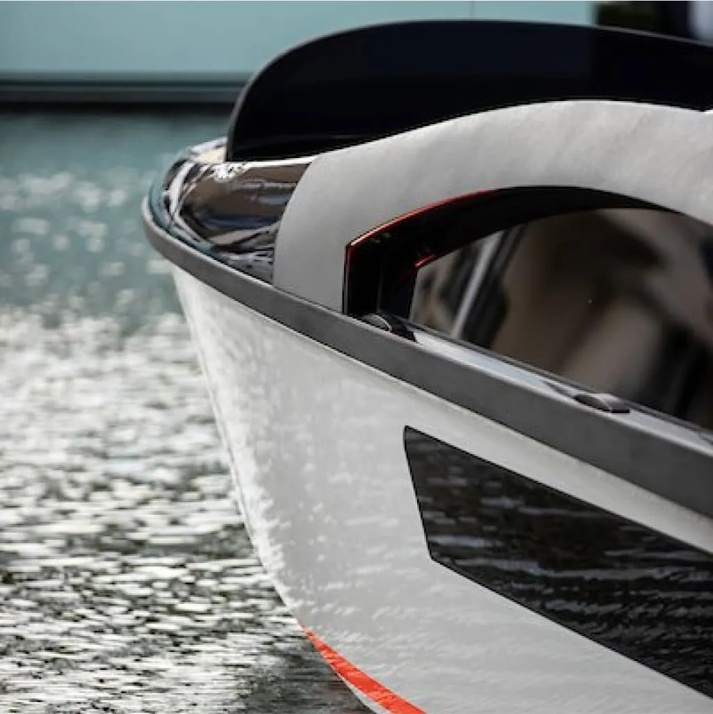 Bow of a composite powerboat on the water, representing Shape's marine work
