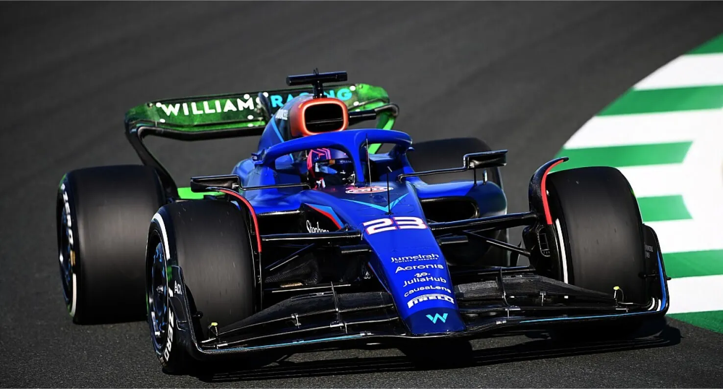 Formula 1 car cornering on track, representing Shape's motorsport work