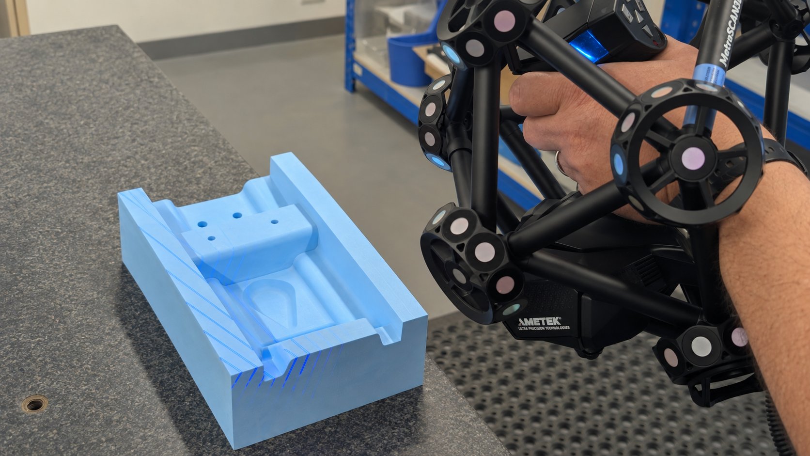 Creaform MetraSCAN BLACK Elite scanning a machined tooling board pattern in Shape's inspection room