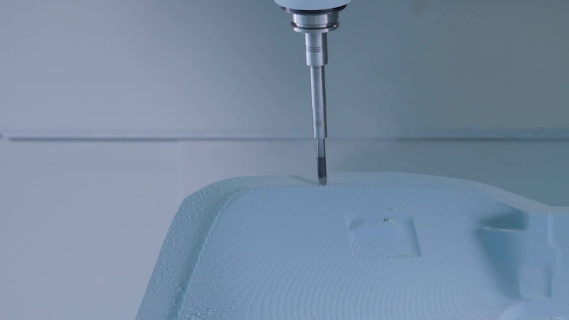 Cutter machining a blue foam part on a 5-axis machine at Shape