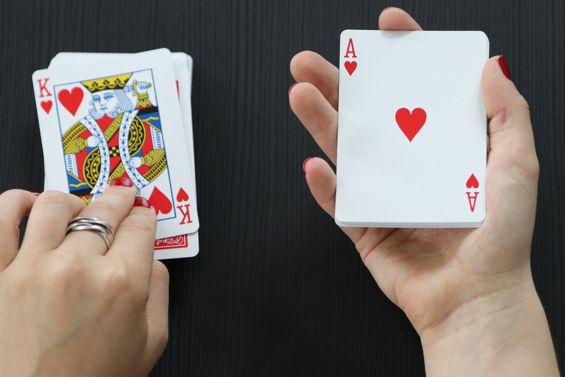 Two people playing a card-based drinking game for couples