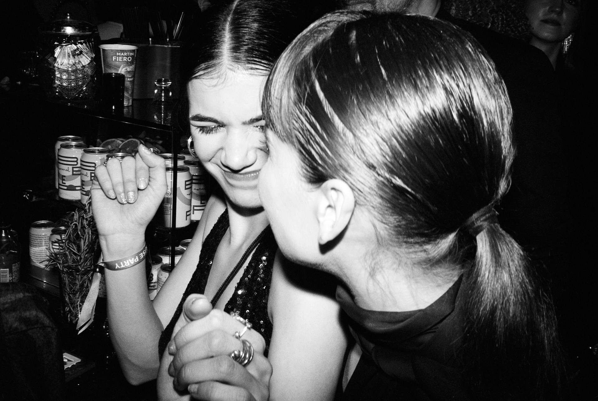 Friends playing truth or drink questions at a house party