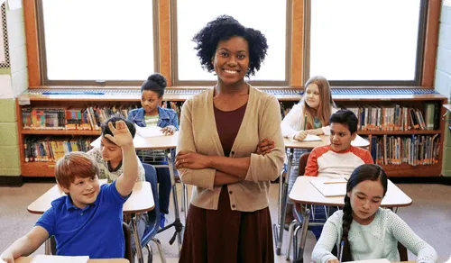 A woman standing in front of a classroom full of children