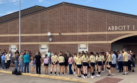 A group of people standing in front of a building