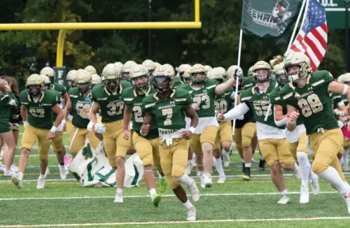 A football team running onto the field.