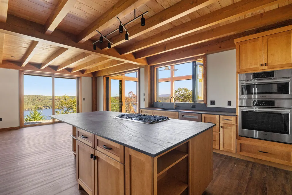A open concept kitchen featuring heavy timber accents.