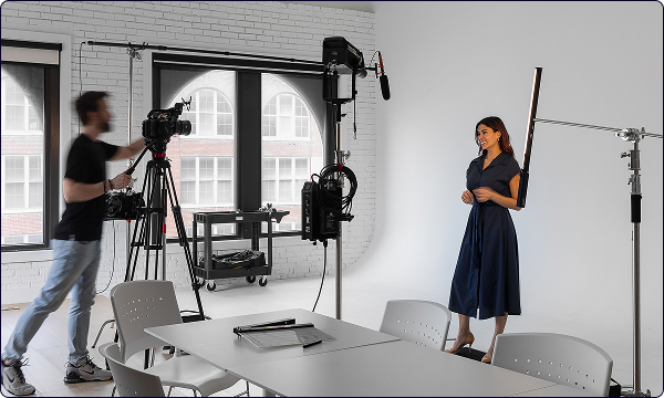 A man taking a professional photo of a woman in a studio