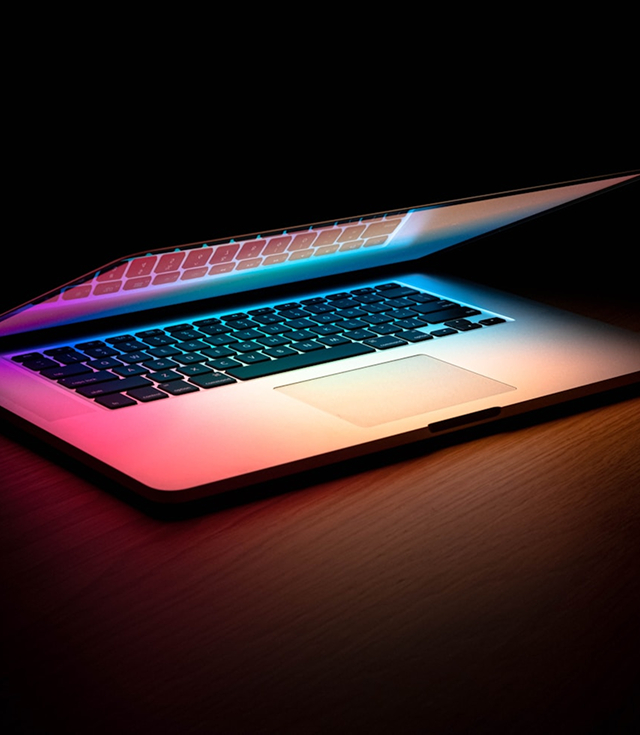 An image of a laptop slightly opened on a desk