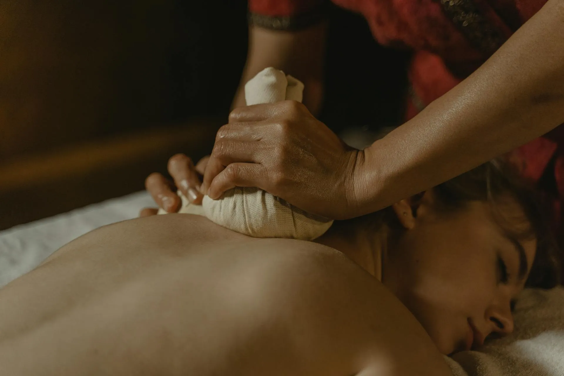 A woman getting a back massage from a man.