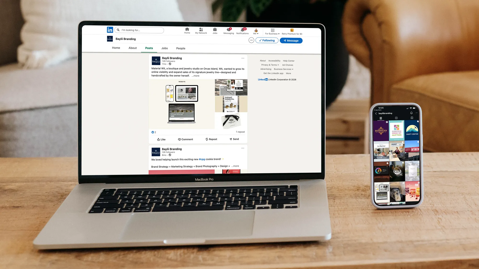 Image of a phone and a computer screen showing a social media feed of Instagram and LinkedIn for Baylii Branding's social media profiles