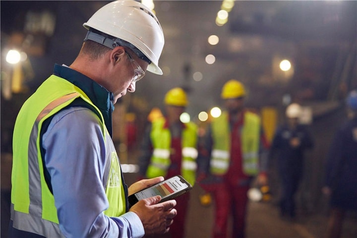 Construction worker using mobile phone on building site