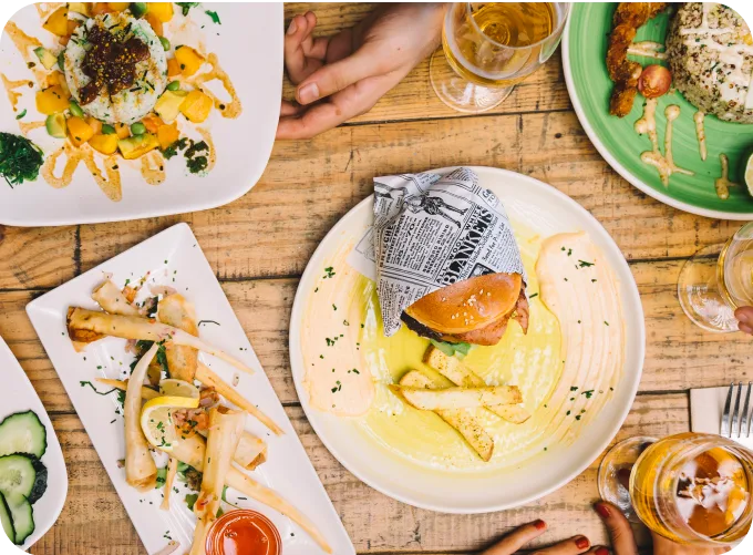 Overhead view of a beautifully arranged table with various dishes, representing the Restaurants industry and highlighting Burq's tailored delivery solutions.