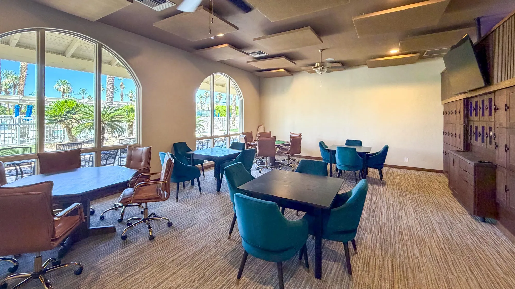The owners lounge game room with ample seating and a fireplace at Outdoor Resort Indio