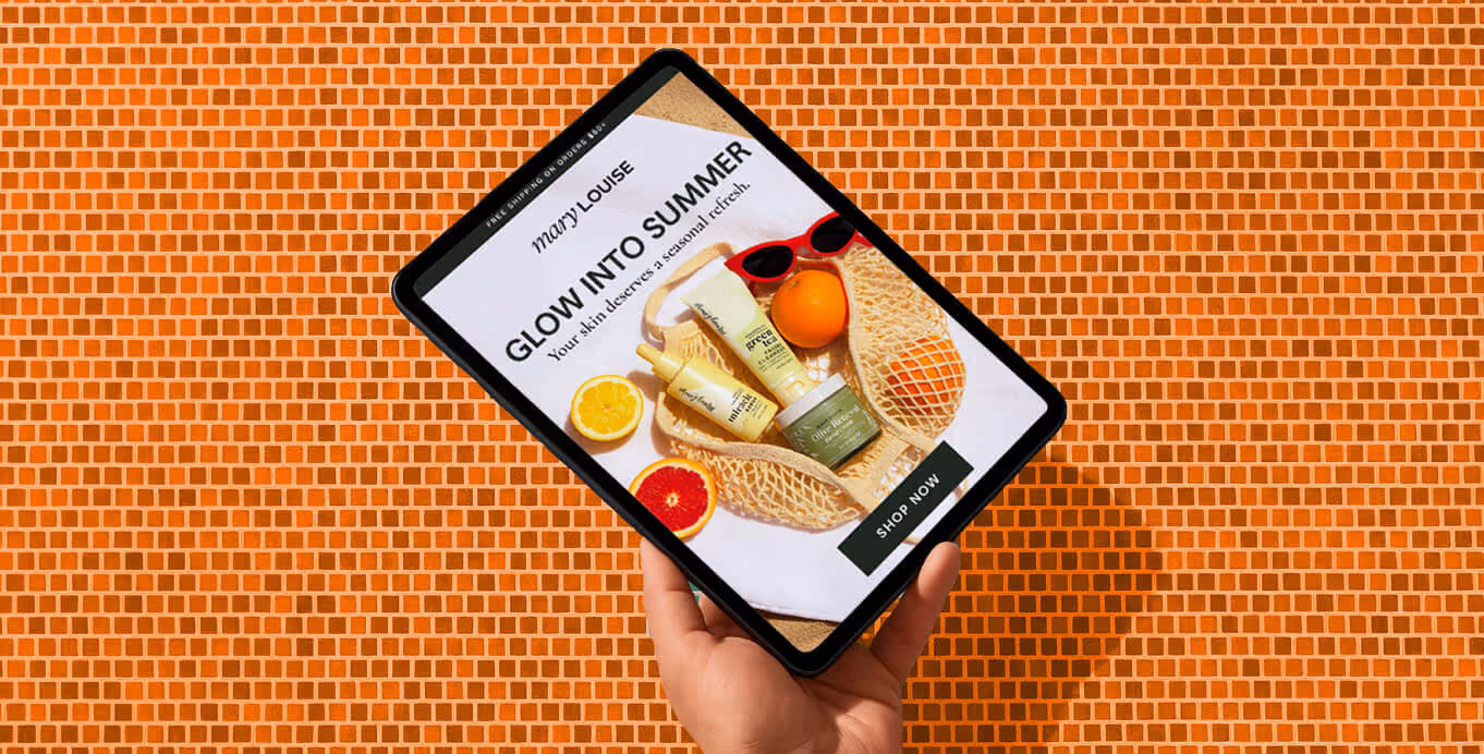 A hand holds a tablet showing Mary Louise skincare products with text “Glow Into Summer” on an orange tiled background.